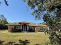 Charming single-story home with a screened entry, well-maintained landscaping, and inviting curb appeal at 31728 Nutmeg Ave, Eustis, FL 32736