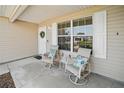 Charming covered porch with comfortable seating, perfect for relaxing and enjoying the outdoors at 3294 Shelby St, The Villages, FL 32162