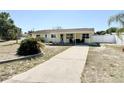 Charming home with a covered porch and long driveway at 33415 Picciola Dr, Fruitland Park, FL 34731