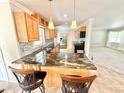 Eat-in kitchen with stone countertops and stainless steel appliances at 33415 Picciola Dr, Fruitland Park, FL 34731