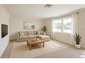 Bright living room featuring neutral tones, natural light, and modern furnishings at 33415 Picciola Dr, Fruitland Park, FL 34731