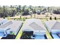 Aerial view of a well-maintained single-story home with fenced backyard, offering privacy and space at 34004 Sky Blossom Cir, Leesburg, FL 34788