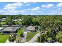 Scenic aerial view highlighting a waterfront home with lush greenery and a peaceful lakeside setting at 34407 Island Dr, Leesburg, FL 34788