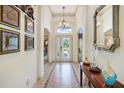 Elegant foyer with decorative tile flooring and arched doorways offering a glimpse into the living spaces at 3723 Belle Rose Dr, Leesburg, FL 34748
