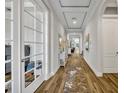 Bright hallway with wood floors, tray ceiling, and archways at 4060 Longbow Dr, Clermont, FL 34711