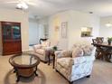 Comfortable living room featuring neutral carpet, and a view of dining room and kitchen through open archways at 4387 Sambourne St, Clermont, FL 34711