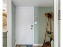 A welcoming entryway features a white door and coastal-themed décor, creating a cozy and inviting atmosphere at 4841 Saxon Dr # E206, New Smyrna Beach, FL 32169