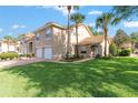 Charming two-story townhome with a well-manicured lawn, two-car garage, and a beautiful terracotta tile roof at 5340 Edgewater Way # 1, Oxford, FL 34484