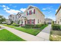 Well-kept townhome with a lush lawn, complemented by colorful shutters and a neat landscape at 644 Orange Belt Loop, Winter Garden, FL 34787
