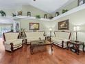 Elegant living room showcasing hardwood floors, ornate furniture, and decorative wall art at 7260 Se 124Th Ln, Belleview, FL 34420