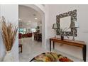 Welcoming foyer with stylish decor leading to an open living and dining area with abundant natural light at 760 Hammond Pl, The Villages, FL 32162