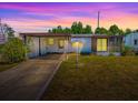 Charming single-story home featuring a covered parking area and a cozy screened-in porch at 819 Hibiscus Dr, The Villages, FL 32159