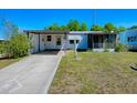 Charming single-story home featuring a covered parking area and a cozy screened-in porch at 819 Hibiscus Dr, The Villages, FL 32159