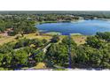 Aerial view showing property lines and proximity to a scenic lake surrounded by lush greenery at 848 Hawk Lndg, Fruitland Park, FL 34731