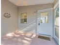 Enclosed porch featuring a ceiling fan, decorative wall art and a 'Happy Place' welcome mat at the front door at 9325 Se 172Nd Garden St, The Villages, FL 32162