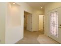 Open foyer showcasing carpet and tile flooring and an ornate decorative glass front door at 9593 Se 124Th Loop, Summerfield, FL 34491