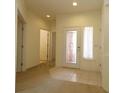 Bright foyer with carpet and tile flooring, decorative glass front door and recessed lighting at 9593 Se 124Th Loop, Summerfield, FL 34491