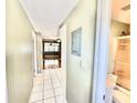 Bright hallway with tile flooring leads to a spacious living area and bathroom at 10301 Us Highway 27 # 98, Clermont, FL 34711