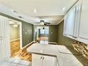 Open kitchen with granite countertops and modern white cabinetry overlooking living area at 10301 Us Highway 27 # 98, Clermont, FL 34711