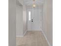 Clean entryway with neutral walls, overhead lighting, and a classic white front door at 1142 Salido Ave, The Villages, FL 32159