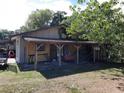 Covered backyard area with a wooden structure, providing ample outdoor storage space and potential for customization at 1431 Ne 53Rd St, Ocala, FL 34479