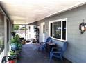 Enclosed back patio with tiled flooring, offering an excellent spot for outdoor relaxation and entertainment with hanging plants and decor at 1431 Ne 53Rd St, Ocala, FL 34479