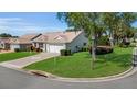 Well-manicured front yard with lush green grass and mature landscaping at 1743 Landrum Ln, The Villages, FL 32162