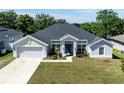 Charming single-Gathering home with a two-car garage, a modern roof and a manicured lawn at 1922 Angel Fish Loop, Leesburg, FL 34748