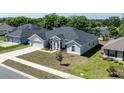 Inviting home with manicured lawn, spacious driveway and beautiful landscaping at 1922 Angel Fish Loop, Leesburg, FL 34748