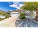 Attractive home featuring a two-car garage, well-manicured landscaping, and sidewalk at 2095 Thornton Ter, The Villages, FL 32162