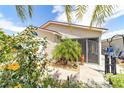 Charming home with flowering shrubs, a cute palm tree and a screened in lanai at 2095 Thornton Ter, The Villages, FL 32162