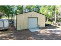 Large outbuilding with a roll-up door, offering ample storage and workspace for various hobbies and projects at 2420 Sr 471, Sumterville, FL 33585
