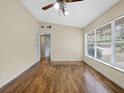 Comfortable living room with hardwood floors, neutral paint, and access to other rooms at 25519 Colmar Ave, Sorrento, FL 32776