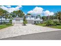 Beautiful two-story home with a long brick driveway and a three-car garage at 26516 Savage Cir, Howey In The Hills, FL 34737