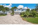Beautiful two-story home with a long brick driveway and a three-car garage at 26516 Savage Cir, Howey In The Hills, FL 34737