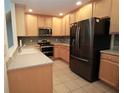 Spacious kitchen features stainless steel appliances, ample cabinetry, and tile flooring at 292 Nautica Mile Dr, Clermont, FL 34711