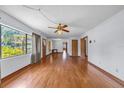 Inviting living room with polished hardwood floors, bright windows, and classic ceiling fan at 2928 Delaney St, Orlando, FL 32806