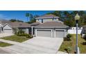 Well-maintained two-story home features a two car garage, well-manicured lawn, and tasteful landscaping at 3002 Bethpage Loop, Mount Dora, FL 32757