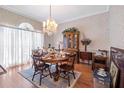 Charming dining room with hardwood floors, a chandelier, and decorative hutch at 301 Waterwood Dr, Yalaha, FL 34797