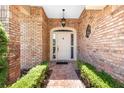 Inviting front entrance featuring a brick walkway, brick walls, and a classic white door at 301 Waterwood Dr, Yalaha, FL 34797