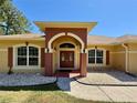 Inviting entryway with a double door entry and decorative pillars at 30554 Quince Ave, Eustis, FL 32736