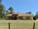 Charming home boasts a well-manicured lawn, beautiful roof, and a welcoming double-door entrance at 30554 Quince Ave, Eustis, FL 32736