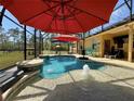 Lush screened-in pool area with an inground pool, water features, and backyard view at 30554 Quince Ave, Eustis, FL 32736