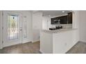 View of modern kitchen with stainless steel appliances and dark cabinets at 3305 Dzuro Dr, Oxford, FL 34484