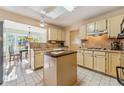 Functional kitchen with an island, neutral countertops, ample cabinet space, and a view into the breakfast nook at 333 Stanley Bell Dr, Mount Dora, FL 32757