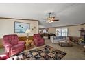 Cozy living room with a ceiling fan, comfortable seating, and classic decor at 37945 Monticello St, Leesburg, FL 34788