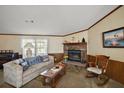 Comfortable living room featuring a fireplace, sofa, and view to the outside at 37945 Monticello St, Leesburg, FL 34788