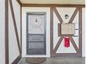 A unit's front entrance features Tudor-style accents, mailbox, light fixture, and door knocker at 500 Newell Hill Rd # 111A, Leesburg, FL 34748