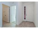 Bright entryway featuring wood-look tile flooring and a view into other rooms of the house at 5024 Balsam Falls Rd, Deland, FL 32724