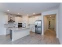 Modern kitchen with white cabinets, stainless steel appliances, tile backsplash, and a central island at 5024 Balsam Falls Rd, Deland, FL 32724